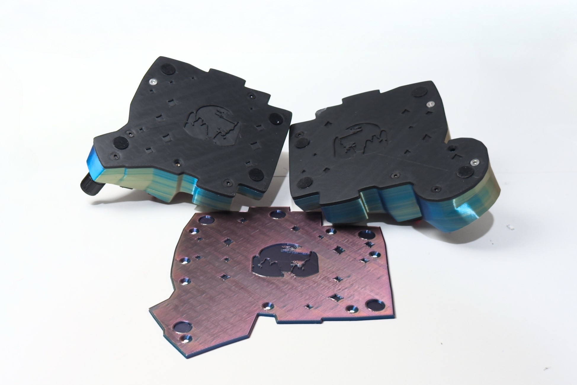 Bottoms of 3D-printed keyboards with plate art